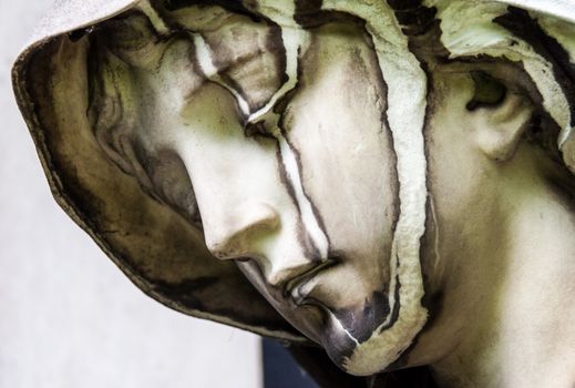 detail of a mourning sculpture on a cemetery