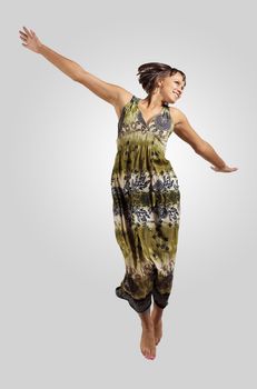 pretty modern slim hip-hop style woman jumping dancing on a grey background