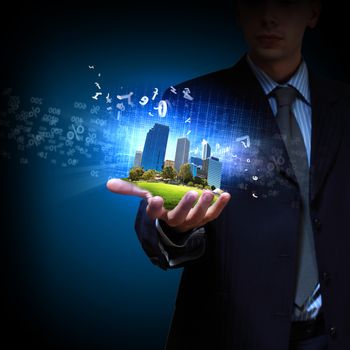 Image of a modern cityscape in the hand of a businessman