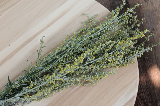 bouquet of dry medicinal herbs on a wooden board