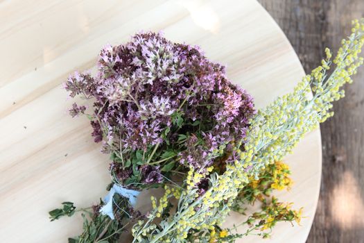 bouquet of dry medicinal herbs on a wooden board