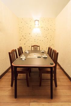 A private room with five chairs in an Asian Restaurant.