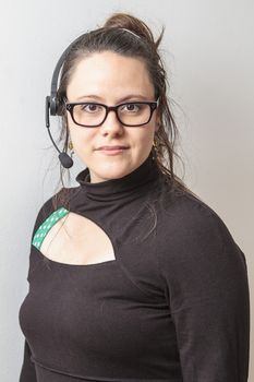 brunet woman with headset against white background