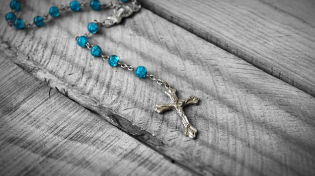 Closeup of a Rosary on wooden background