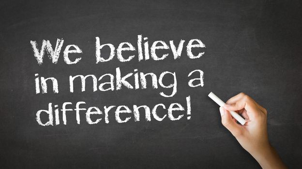 A person drawing and pointing at a We believe in making a difference Chalk Illustration