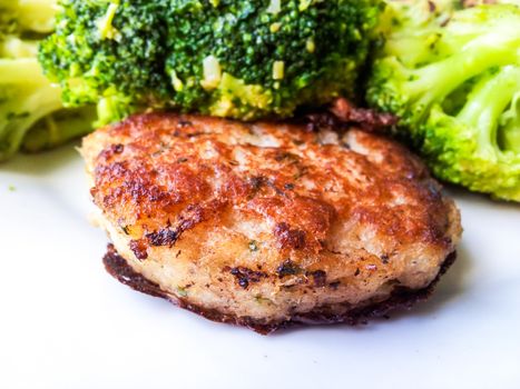 Fresh white fish cake, with beautiful broccoli on the side