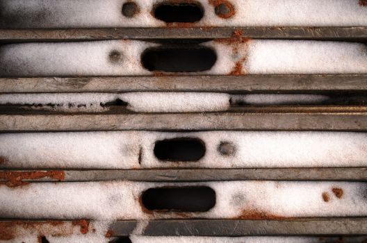 background of bulldozer excavator iron catterpillar covered with snow in winter closeup.