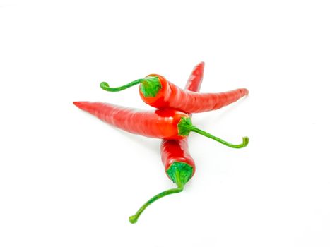 Three red chilies isolated towards white background