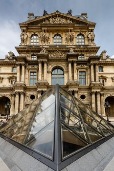 PARIS - JULY 1: Glass Pyramid in Front of the Louvre Museum on July 1, 2013. The Louvre is one of the world's largest museums in Paris. Nearly 35,000 objects are exhibited here.