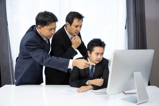 Team of businessmen analysis their business with computer desktop