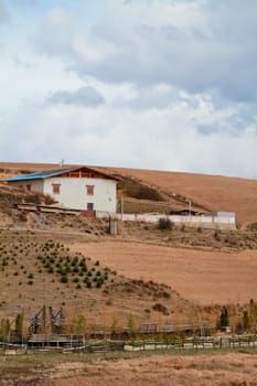 House on mountain in countryside with sky