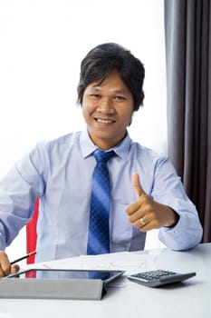 Happy businessman working with tablet computer