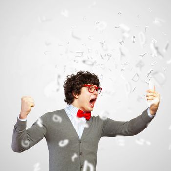 Young businessman with a red tie shouting furiously at his mobile phone