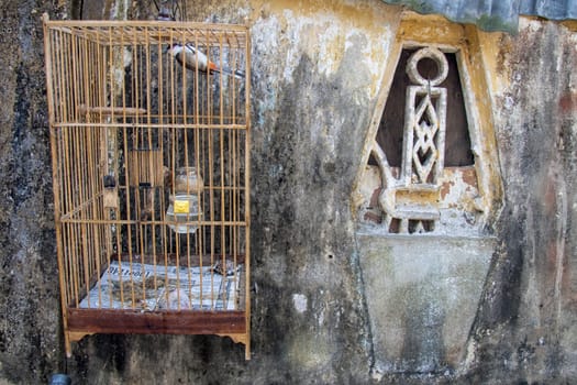 Birdcage and window on old house in Hoi An, Vietnam