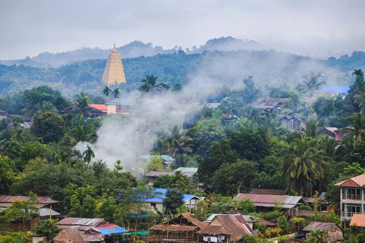 Golden pagpda and the morning mist at sangklaburi, thailand