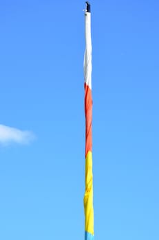 White red and yellow rolled up flag  