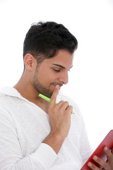 Thoughtful man reading from a clipboard standing concentrating with his hand to his chin, isolated on white