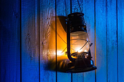 The old kerosene lantern hanging on the yellow wooden wall