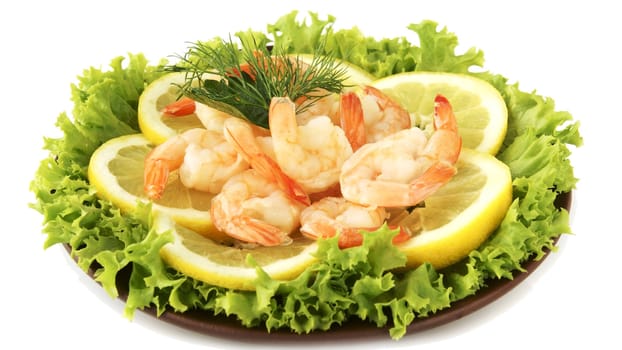 Boiled shrimps with lemon and lettuce leaves on plate, isolated on white 