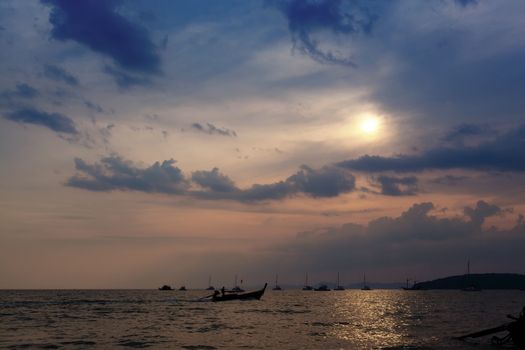 Longtail boats against a sunset. Ao-Nang, Thailand.