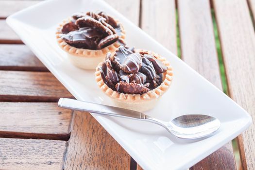 Chocolate crispy tarts on white plate, stock photo