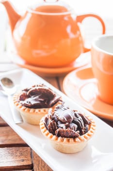 Tea time with crispy chocolate tarts, stock photo