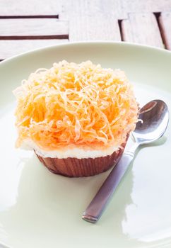 Gold egg yolk thread cup cake on ceramic dish, stock photo