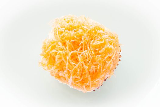 Gold egg yolk thread topped on cup cake, stock photo