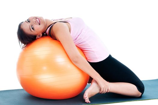 Portrait of a fitness woman working out on balance ball