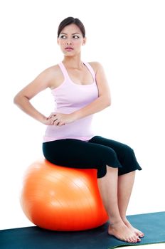 Portrait of a fitness woman sitting on balance ball