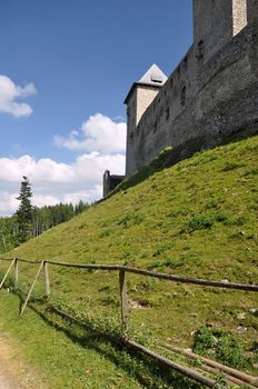 Old castle on a green hill in the summer sun