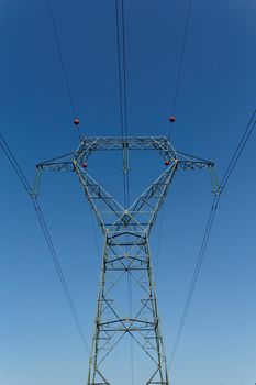 Detail of electricity pylon against blue sky 