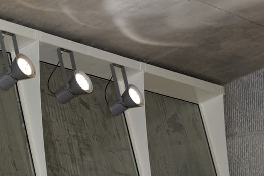 industrial lights on the wall inside a building