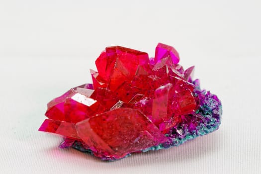 close up of crystals in ruby color on white background (red crystal)