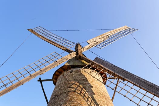 Old wooden windmill against the blue sky