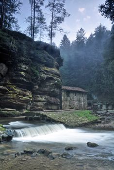 Old Dolsky mill with Kamenice river and fog