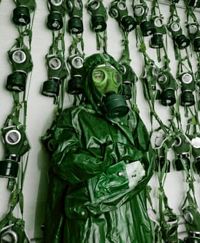 old military gas masks on a soldier woman with chemical protective suit green