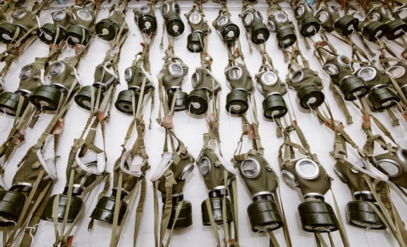 old military gas masks hanging on each other