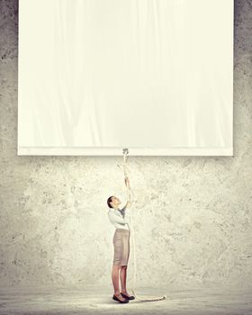 Businesswoman pulling blank banner. Place for text
