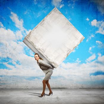 Image of businesswoman carrying big white cube on her back. Place for text