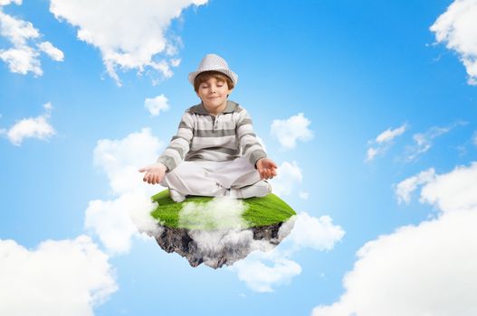 Image of little boy sitting on clouds and relaxing