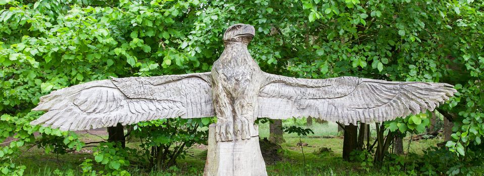 Wood craft of a eagle on top of a bench