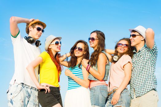 group of young people wearing sunglasses and hats hugging and standing in a row, spending time with friends