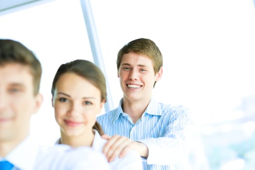 portrait of a young businessman standing in a row with his colleagues, concept of teamwork