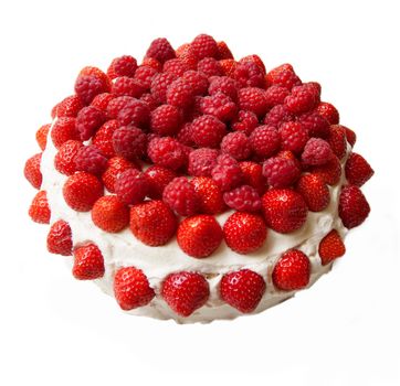 A layered sponge cake decorated with strawberries and raspberries. Isolated on white