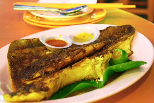 Grilled skate-wing in a restaruant on Jalan Alor in Kuala Lumpur, Malaysia. Skate is a famous local speciality.