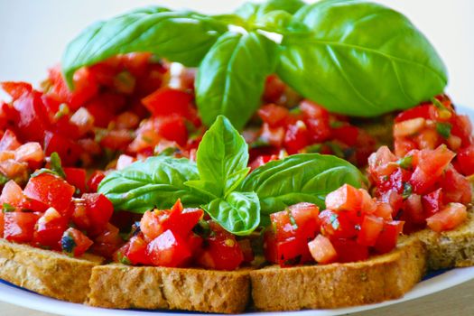 Crusty bruschetta with fresh diced tomatoes, garlic and basil is a popular Italian antipasto served in most retaurants