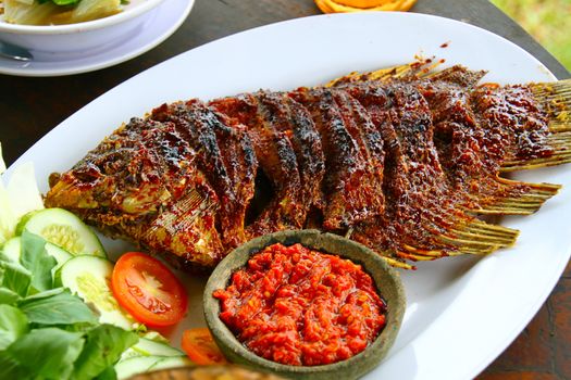 Grilled giant Gourami fish in a restaurant in Java, Indonesia. Gourami is a fresh-water fish and considered the most delicious fish in Indonesia.