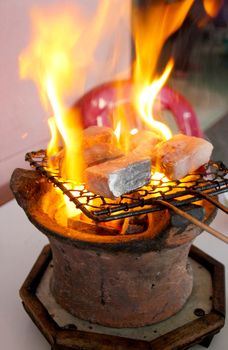 Grilled barracuda fish in a restaurant in Nha Trang, Vietnam. A clay pot gridle is a popular utility to grill fresh fish and meats in Vietnam