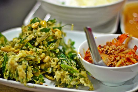 Fried morning glory vegetable with meat sauce in a restaurant in Bangkok, Thailand.